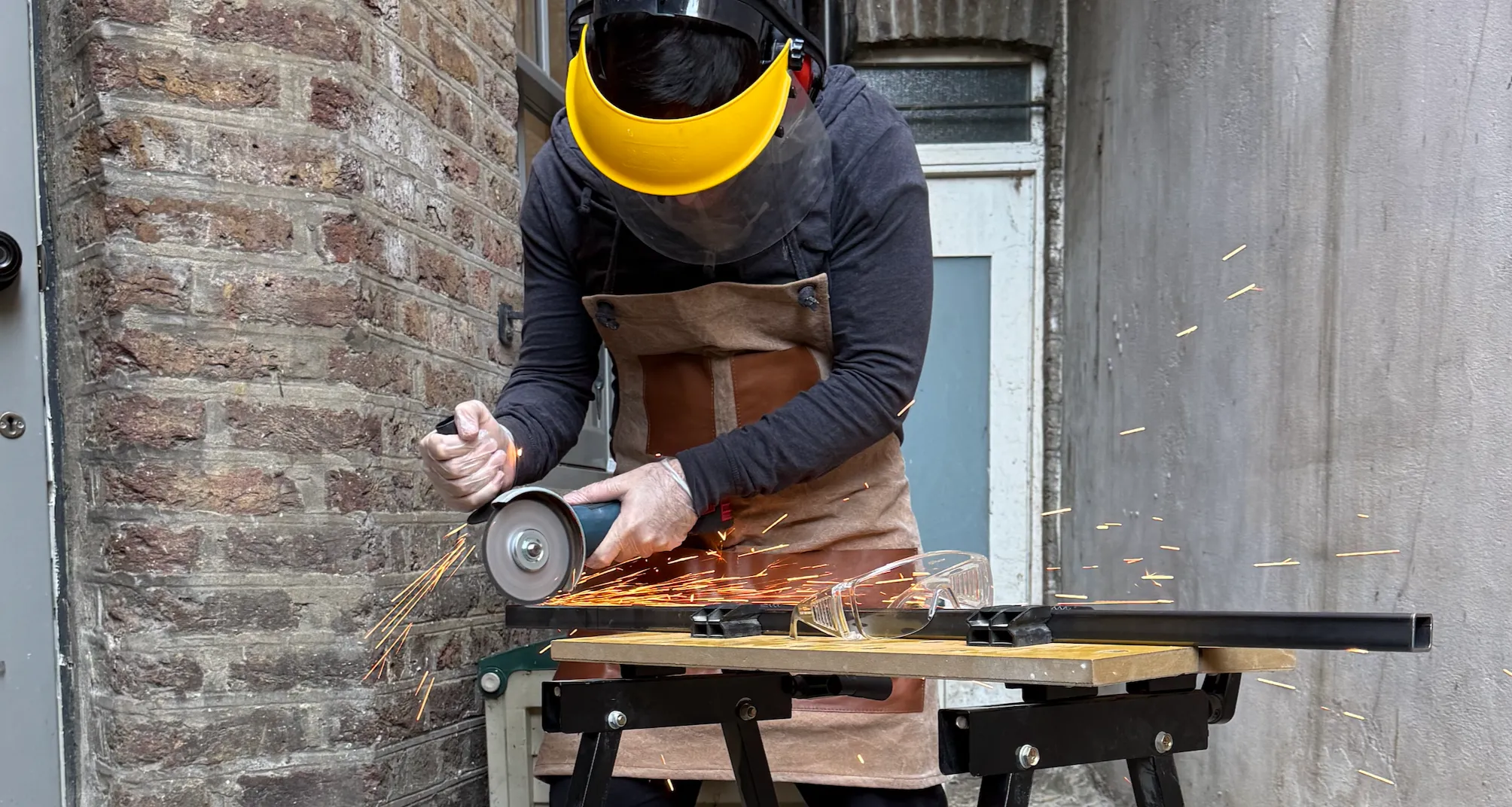 Cutting the steel box with an angle grinder